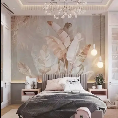Kids bedroom with a tropical leaf mural wallpaper behind a grey channel-tufted headboard, twin glass globe pendant lights,