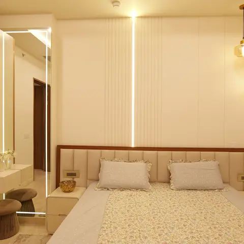 Master bedroom with a backlit fluted panel headboard wall lit by a vertical LED strip, amber glass pendant lights, and a