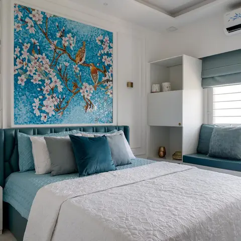 a teal tufted-leather upholstered bed beneath a large turquoise mosaic mural of blossoming branches and birds, with a