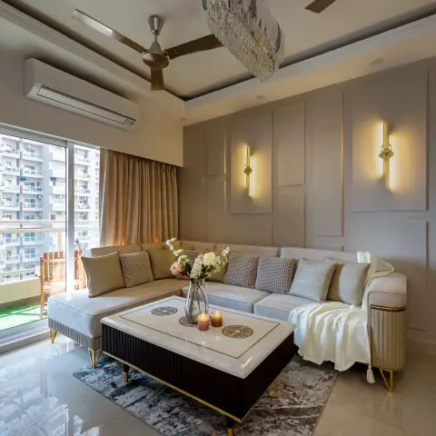 Living room with an L-shaped sectional sofa around a black-and-marble coffee table, a feather-and-crystal chandelier, and
