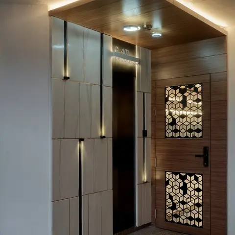 apartment entrance with a geometric cubed-jaali wood and glass main door under a cove-lit wood-clad canopy ceiling