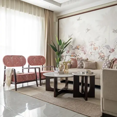 Living room with a framed floral bird-print wallpaper mural, a sputnik-style gold chandelier, a cream sofa flanked by pink