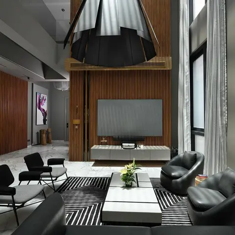 Double-height living room with a fluted wood-slat TV wall, black leather sofas and armchairs on a graphic black-and-white