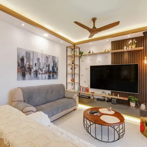Living room with a fluted walnut TV feature wall, cluster bulb pendant lighting, a cove-lit tray ceiling, a black ladder