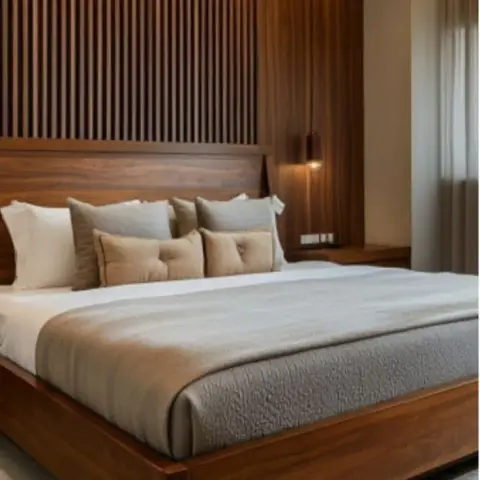 King bed with a solid wood platform frame set against a fluted wood-slat wall with a hanging pendant light beside the