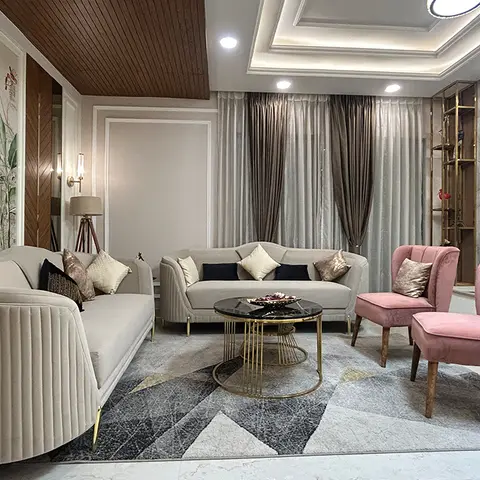 Living room with a botanical mural wallpaper feature wall, wood-clad cove ceiling, marble-and-brass TV wall, channel-tufted