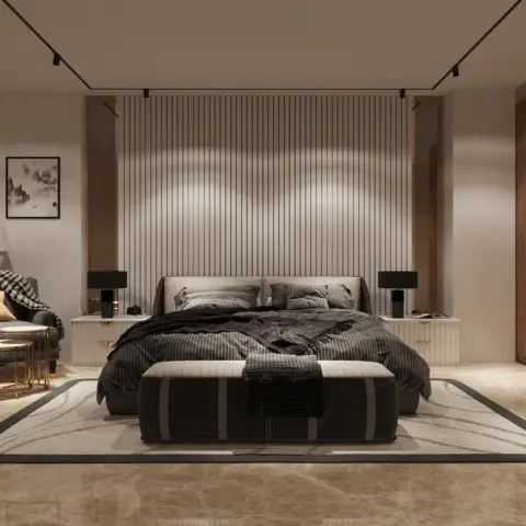 Charcoal-dressed bed on a beige marble floor, with a floor-to-ceiling fluted panel behind the headboard, a black-framed
