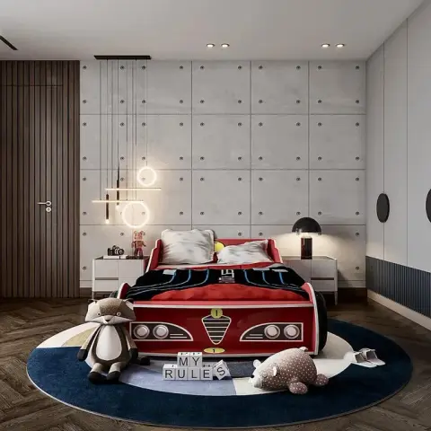 Child's room built around a red racing-car bed on a round navy-and-cream rug, with a bolted faux-concrete panel wall behind,