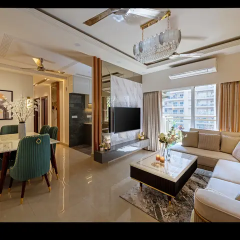 Open-plan living-dining space with a beige L-shaped sectional sofa, marble-top dining table with green velvet chairs, and a