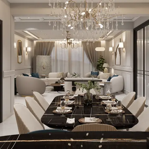 A dining room with a book-matched black marble table set for eight beneath an oversized crystal branch chandelier,