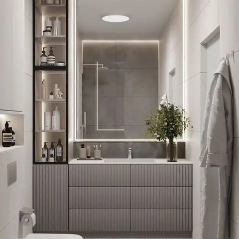 Bathroom with a fluted grey vanity, backlit LED-framed mirror, large-format grey wall tiles, and a wall-hung WC beside an