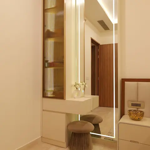 Bedroom dressing nook with a full-length LED-backlit mirror, a fluted amber-glass display cabinet, and two mushroom-shaped