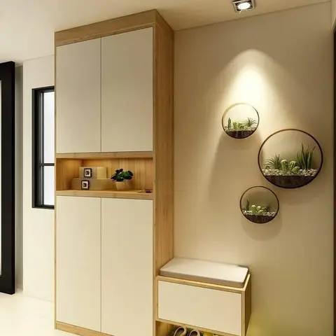 Entryway with a tall wood-and-white shoe cabinet with an integrated cushioned bench, and three circular wall-mounted