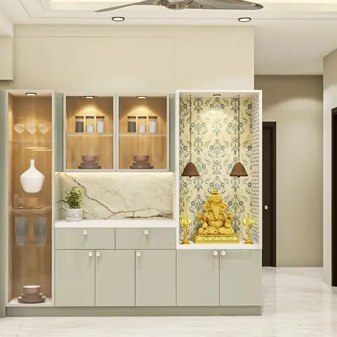 A built-in pooja niche with wallpapered temple-motif backdrop housing a brass Ganesh idol and hanging bells, beside