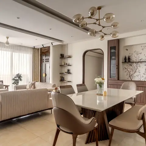 Open dining area with a mid-century sputnik chandelier over a marble-top table, a walnut crockery unit inset with a