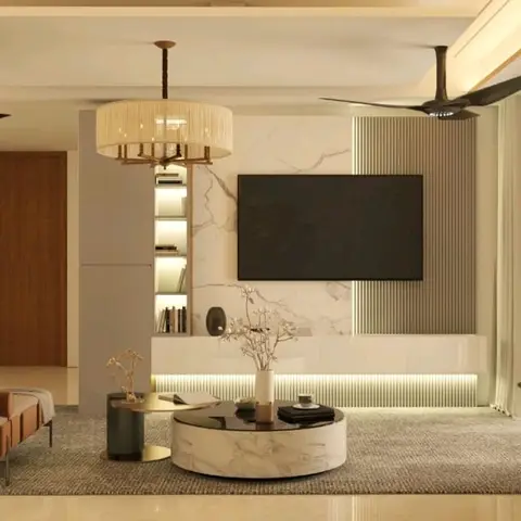 Living room with a marble-clad TV feature wall backed by fluted wood panelling, a drum-shade pendant chandelier, and a round