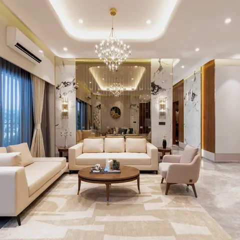 Two cream sofas and a blush armchair around a round wood coffee table, beneath a tiered crystal chandelier and backed by a
