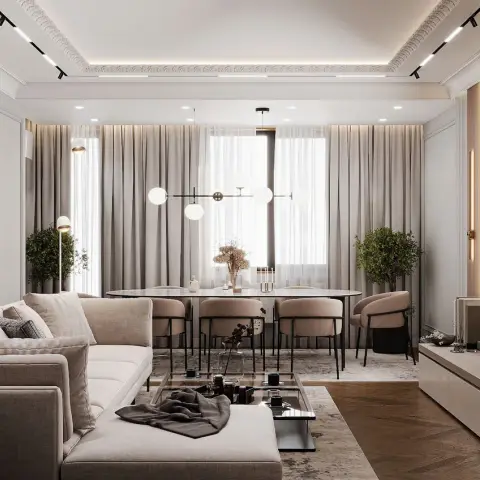 A neutral-toned living-dining space with a beige sectional sofa, an oval dining table under a globe pendant chandelier, wood
