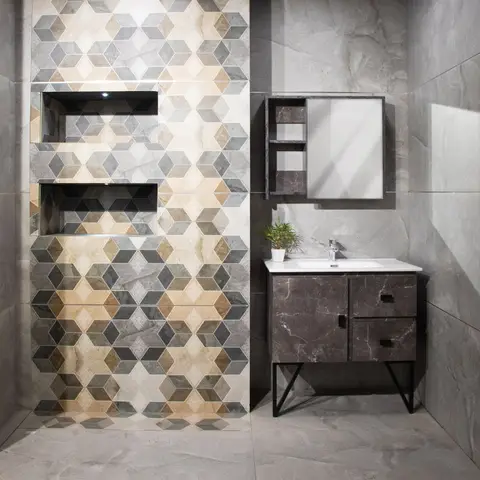 Bathroom vanity wall with a geometric hexagon-pattern mosaic tile feature framing built-in display niches, paired with a