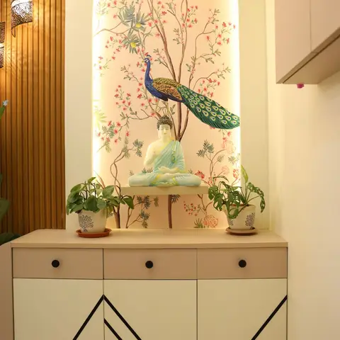 Entrance console with a backlit arched wallpaper niche featuring a peacock-and-blossom mural, a jade Buddha statue, potted