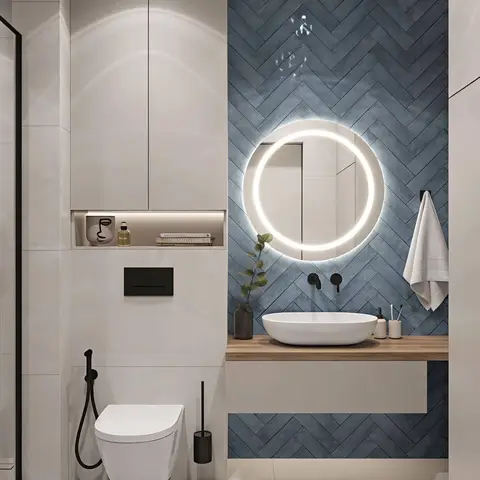 Bathroom with a blue herringbone-tile feature wall, a backlit round mirror and a floating wood vanity with a vessel basin