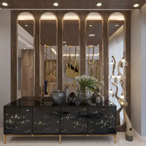 Entrance console vignette with a black lacquered bird-motif cabinet, arched brass-edged mirrors, and a driftwood floor lamp