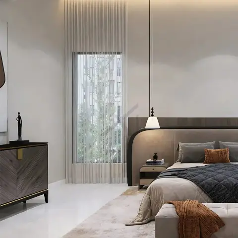 Primary bedroom with a curved upholstered headboard built into a wood wall panel, a brass-accented console with sculptural